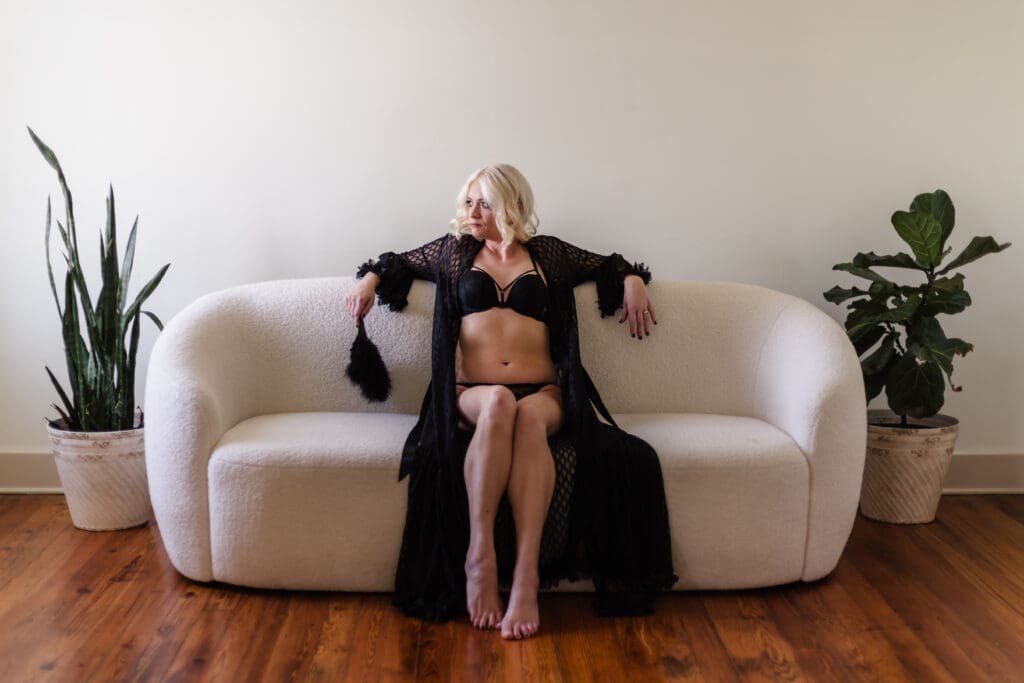 woman sitting on a couch during knoxville boudoir photography session