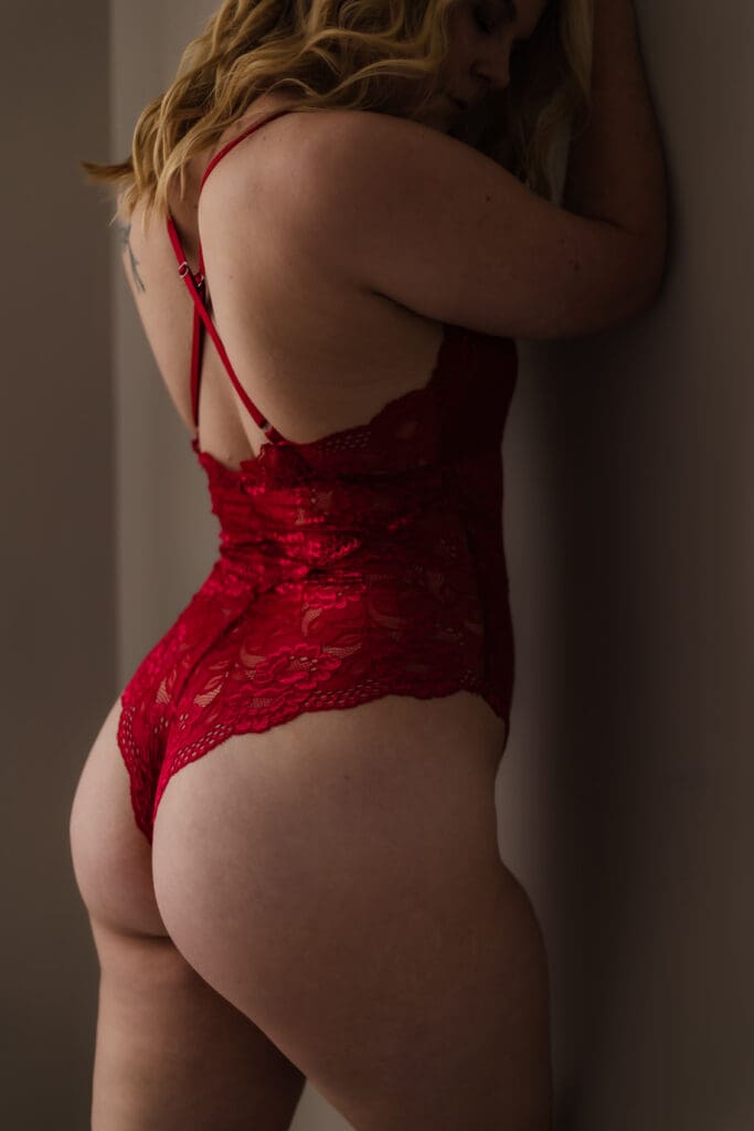 woman leaning against wall during knoxville boudoir photography session