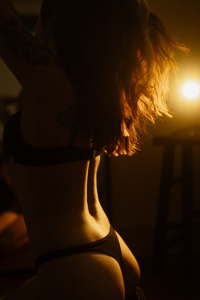 woman flipping hair during golden hour boudoir session at the lightfoot studio in knoxville